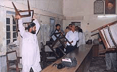 A Municipal Councillor picks up a chair during an alteration at a meeting in Ambala City on Friday.