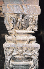 An intricately carved wooden pillar in Mahadev Temple