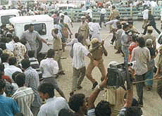 Groups of DMK volunteers, who became violent on seeing former Chief Minister M. Karunanidhi lodged in Central Prison, were chased away by the police at Chennai on Saturday. 