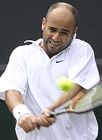 Andre Agassi of the U.S returns the ball to Nicolas Massu of Chile during their third round match at Wimbledon on Saturday. 