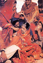 A bride being blessed after Anandkaraj