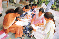 Students of Master Tara Singh Memorial College for Women fill in their admission forms as the colleges re-opened on Monday.