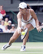 Jennifer Capriati of the USA plays a return to compatriot Serena Williams during their women's quarter-finals match at Wimbledon on Tuesday.