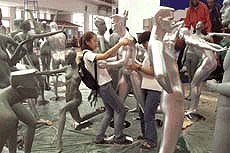 A Chinese worker prepares to move a mannequin for an exhibition in Beijing on Wednesday. Chinese are aggressively advertising and promoting their products to meet competition from foreign products.