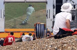 Cricket fans watch England play Australia on a giant TV screen on Britain's Brighton beach on Thursday.