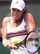 Jennifer Capriati of the U.S. plays a return to Justine Henin of Belgium during their women's semifinal match at Wimbledon on Thursday.