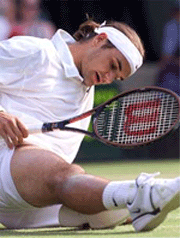 Switzerland's Roger Federer slips on the grass during his men's quarterfinal match against Britain's Tim Henman at Wimbledon on Wednesday.