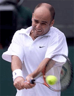 Andre Agassi of the U.S. plays a return to Pat Rafter of Australia during their men's semifinal match at Wimbledon on Friday.