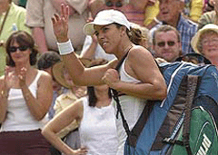 Jennifer Capriati waves as she leaves the court after losing her match against Belgiums Justine Henin in their womens singles semifinal match on the Centre Court, at Wimbledon on Thursday. 