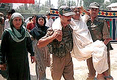 A Kashmiri woman patient being carried by BSF soldiers during a free medical camp organised by 51Bn of BSF at Natipora Chanpora in Srinagar on Saturday.