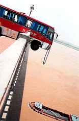 An empty bus dangles on the Nanjing Yangtze River Bridge in eastern China's Jiangsu province after all passengers were rescued Wednesday.