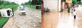 An overturned jeep on a Chandigarh road after a heavy shower on Saturday and (right) residents of Ram Darbar find it hard to cross the flooded streets of the colony. 