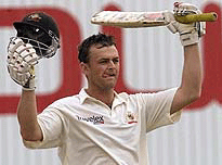 Australia's Adam Gilchrist celebrates his century against England on the third day of the first Test in the Ashes Tour at Edgbaston on Saturday.