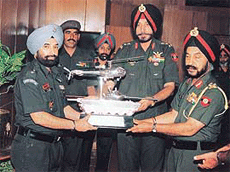 Lieut-Col A.S. Randhawa (Left) receives the Flight Safety Trophy from Lieut-Gen Surjit Singh GOC-in-C, Western Command at Chandimandir on Monday.