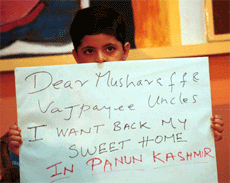 Son of a displaced Kashmiri Pandit holds a placard demanding return of Kashmiri Pandits during a Press conference organised by Panun Kashmir in  Mumbai on Tuesday.