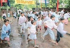 Enthusiastic children brave the rain to participate in a rally organised to mark World Population Day at the Sector 18 Sports Training Centre , in Chandigarh on Wednesday.