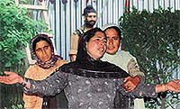 A relative wails as a policeman looks on after Nazir Ahmad was shot dead at Pattan, 27 km north of Srinagar, on Wednesday.