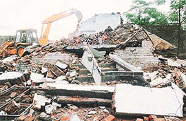 A JCB machine demolishes an unauthorised structure in Chandigarh Sector 49-D on Thursday.