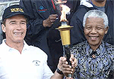 Former President Nelson Mandela and actor Arnold Schwarzenegger hold a symbolic "Flame of Hope" at a ceremony outside Mandela's old prison cell on Robben Island on Thursday.