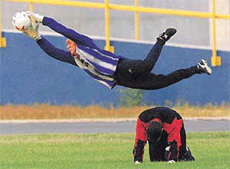 Venezuela's goalie Manuel Sanhouse jumps over Rafael Dudamel during a training session in Barranquilla on Thursday. Venezuela will face Chile in a second round Copa America match on Saturday