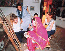 Foreign students admire a model of a village girl at the Rural Museum.