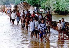 Indian villagers walk through a flooded street after being made homeless in the town of Dihakhalla in the eastern state of Orissa on Saturday. 