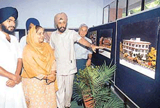 The Chief Administrator of PUDA, Mr K.B.S. Sidhu, explains a point about the new PUDA head office complex at an exhibition organised at the community centre in Phase 3 B2, SAS Nagar, on Tuesday.