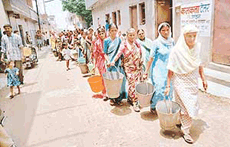 Hundreds of villagers of Darua queue up at the Chandigarh railway station on Wednesday, as they have been doing for the past two months, to fetch water.