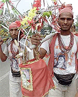 Indian worshipers of the Hindu god Lord Shiva carry holy water from the Ganges River while walking through New Delhi on Wednesday.