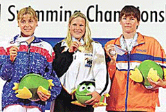 Germany's Peggy Busche (C) holds her gold medal with Russia's Irina Abyssova (silver) and Edith van Dijk of the Netherlands (bronze) at the medal ceremony for the women's open water 10 km swim at the World Swimming Championships in Fukuoka on Thursday.