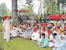 Kirti Kisan Union members sit in dharna outside the Deputy Commissioners office at Ludhiana on Friday.