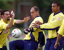 Brazilian goalkeeper Marcos, center, fights for the ball against teammates forward Guilherme, left and goalkeeper Dida during a practice session in Cali, Colombia on Thursday.