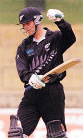 New Zealand batsman Nathan Astle waves his bat after scoring a century during the one-day triangular series cricket encounter against India at the R. Paremadasa Stadium in Colombo on Friday.