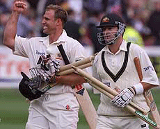 Australias batsman Matthew Hayden (L) and Mark Waugh (R) celebrates as they leave the field after defeating England on the fourth days play of the second Ashes Test at Lords on Sunday.