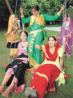 Girls take a swing during the Teej celebrations at Chandigarh Press Club on Sunday.