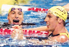 Australias Ian Thorpe (L) reacts after setting a new world record in the mens 400 m freestyle final at the 9th World Swimming Championships in Fukuoka on Sunday, as compatriot Grant Hackett congratulates him.