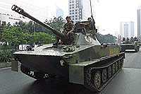 Indonesian military tanks drive down the main street through Jakarta's business district on Monday.