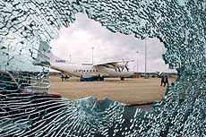 A view of Colombo International Airport through the cracked glass of the departure terminal following a pre-dawn attack in Colombo on Tuesday. 