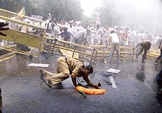 A policeman loses his balance as water cannon is used to disperse the agitated BJP protesters against the killings of Amarnath pilgrims near the Pakistan High Commission in New Delhi on Tuesday.