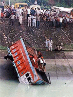 Rescuers search for bodies in a truck which fell into a canal in Kiratpur Sahib in which about 50 pilgrims were feared drowned on Monday.