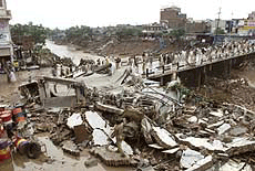 Military rescue workers monitor Gawalmandi bridge and surrounding areas after it was hit by the heavy rainfall in Rawalpindi on Tuesday. 