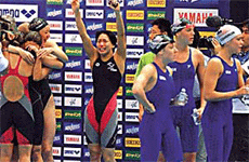 Members of the Japanese womens 4x200 metre freestyle relay team (L) celebrate as US team members walk away after the Japanese appeared to have been awarded the bronze medal following an initial disqualification of the Americans at the World Swimming Championships in Fukuoka on Wednesday. 
