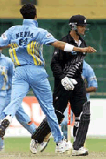 Indian bowler Ashish Nehra (L) celebrates the dismissal of New Zealand opening batsman Nathan Astle 