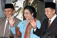 Indonesian President Megawati Sukarnoputri and new Vice-President Hamzah Haz (right) and the chairman of the National Assembly, Amien Rais, wave to the media after the swearing-in ceremony for Haz at Parliament in Jakarta on Thursday.