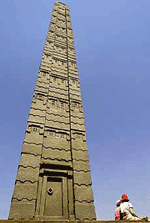 Two tourists relax at the base of the Ethiopian obelisk in Rome on Thursday.