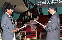 Nepal's new Prime Minister Sher Bahadur Deuba, 55, left, takes the oath of office from King Gyanendra, right, at Narayan Hiti Royal Palace in Katmandu on Thursday.