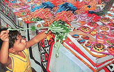 A little baby selects a rakhi at a Sector 30 stall in Chandigarh on Friday.