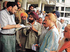 Ludhiana Deputy Commissioner S.K. Sandhu studies the documents of Aisolde Litter.