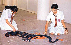 Students of Kundan Vidya Mandir make rangoli designs.