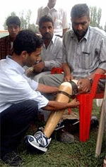 An Assistant Sub-Inspector of police, Abdul Khaliq being provided with artificial limb at a camp organised by the Jammu and Kashmir police in Srinagar on Monday. Khaliq lost his leg during a militant attack.